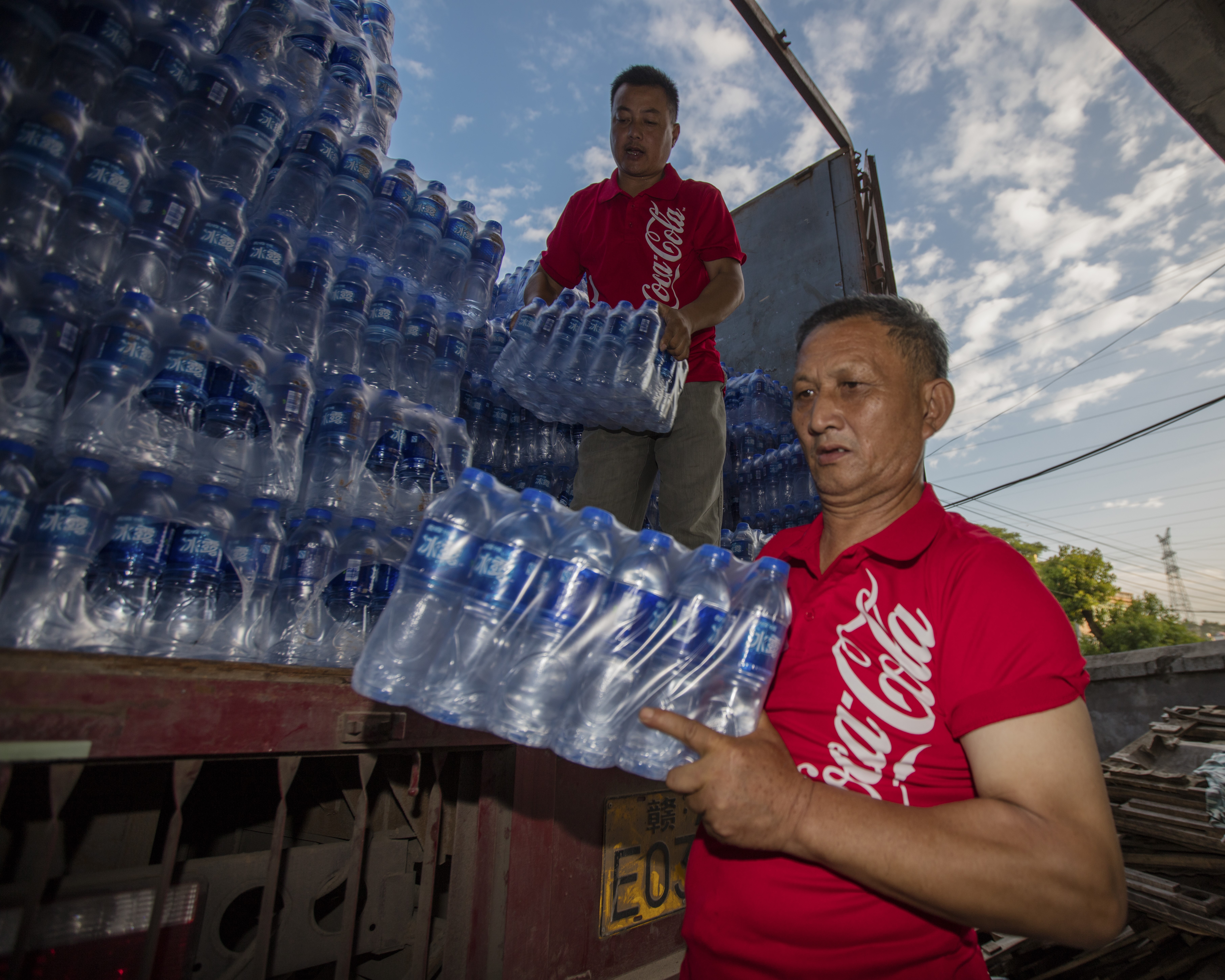 Company employees deliver bottled water for disaster relief