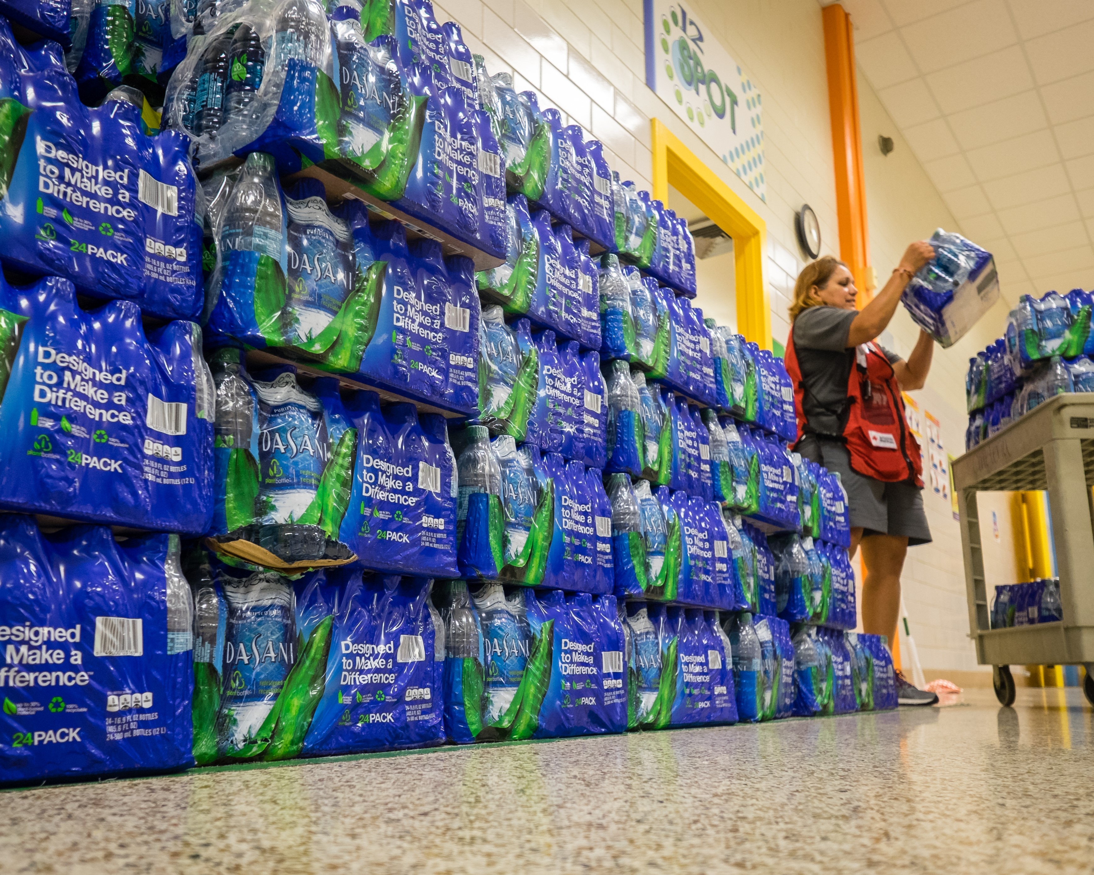 Volunteers load Dasani water at a shelter for Hurricane Harvey disaster relief